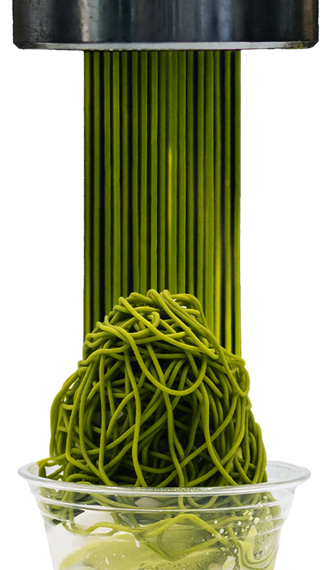 The matcha sauce is being pressed out of a metal extruder and heaped into a clear cup.